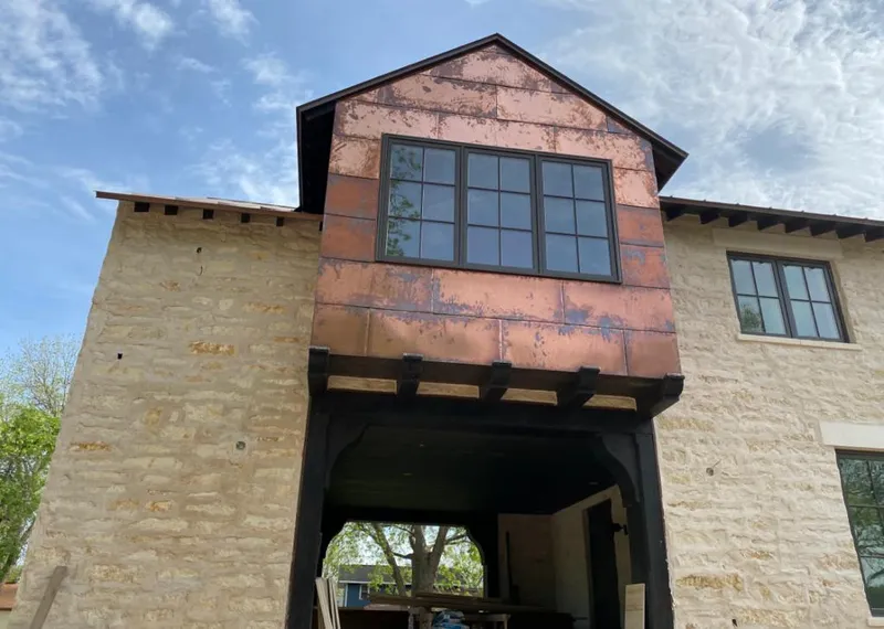 Copper metal panel facade on a stone building for Skylight Installation in Spring Valley Lake